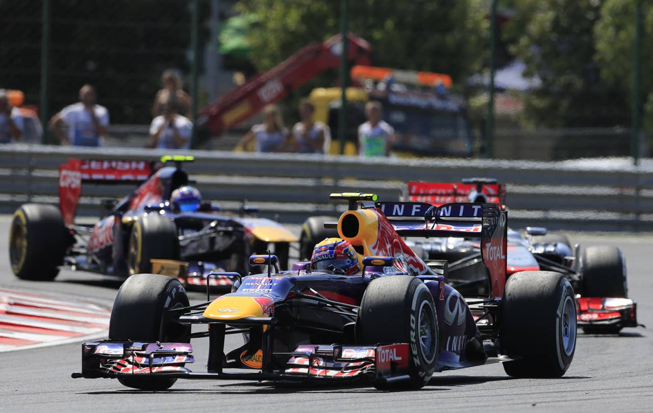 Scuderia Toro Rosso's Australian driver Daniel Ricciardo and  Red Bull Racing's Australian driver Mark Webber drive at the Hungaroring circuit in Budapest on July 28, 2013 during the Hungarian Formula One Grand Prix. AFP PHOTO / ALEXANDER KLEINALEXANDER KLEIN/AFP/Getty Images