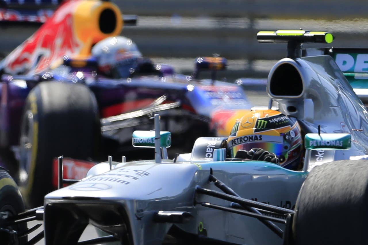 Red Bull Racing's German driver Sebastian Vettel and Mercedes'  British driver Lewis Hamilton  drive at the Hungaroring circuit in Budapest on July 28, 2013 during the Hungarian Formula One Grand Prix. AFP PHOTO / ALEXANDER KLEINALEXANDER KLEIN/AFP/Getty Images