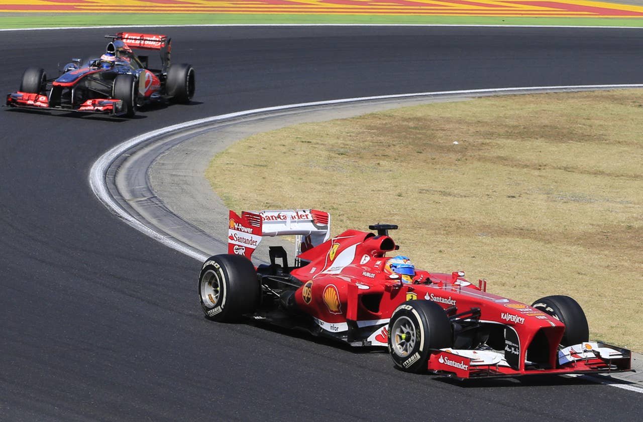 McLaren Mercedes' British driver Jenson Button and Ferrari's Spanish driver Fernando Alonso  drive at the Hungaroring circuit in Budapest on July 28, 2013 during the Hungarian Formula One Grand Prix. AFP PHOTO / ALEXANDER KLEINALEXANDER KLEIN/AFP/Getty Images