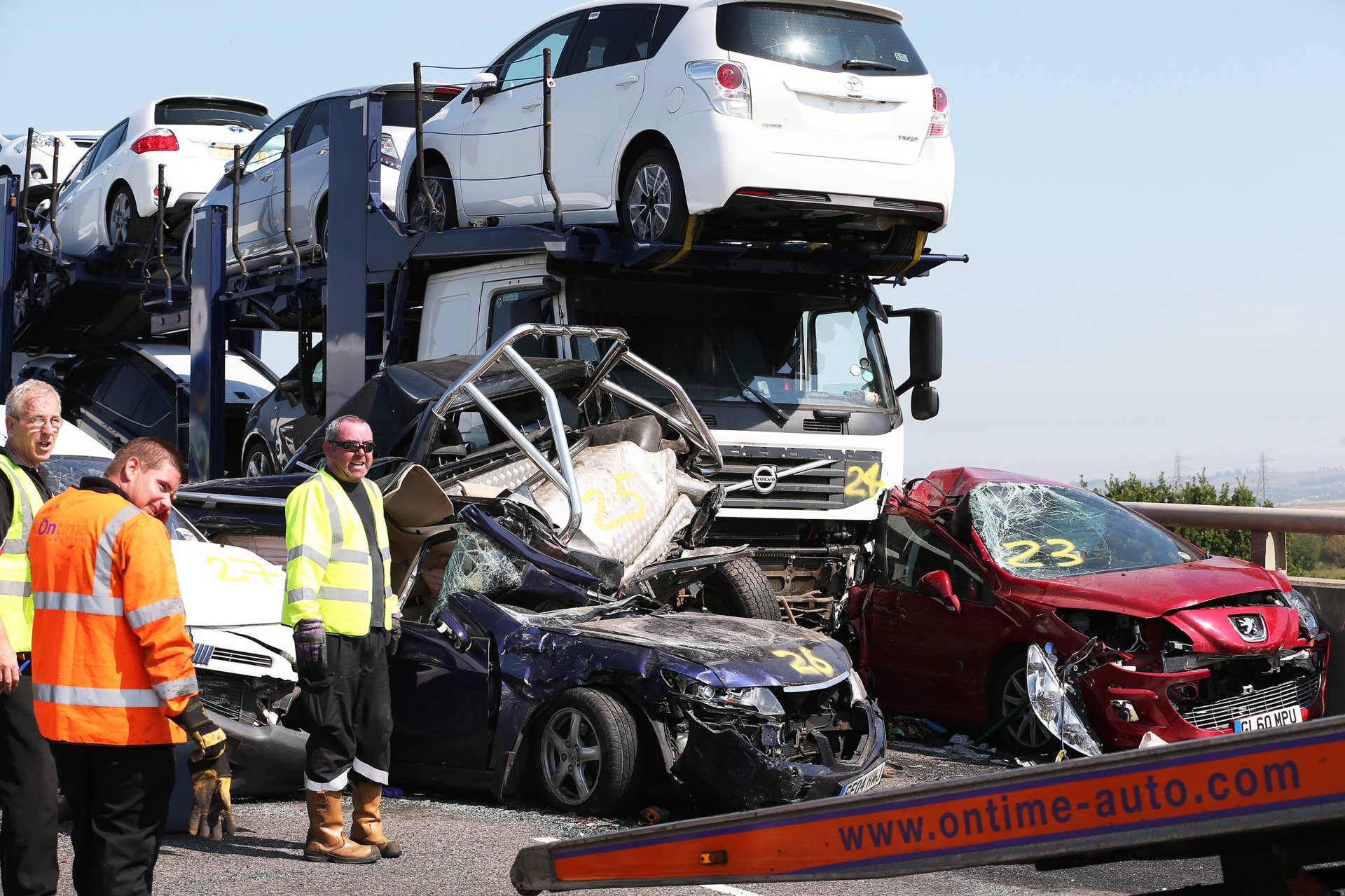 ISLE OF SHEPPEY, KENT - SEPTEMBER 05:  Vehicle recovery workers attend the site of a major traffic accident on the A249 Sheppey crossing bridge in Kent on September 5, 2013 in Isle of Sheppey, Kent. Over 130 vehicles were involved in the series of accidents, with thick fog blamed for poor visibility. The crash occurred around 07:15AM BST, with at least 8 people suffering serious injuries, and approximately 60 people treated for minor injuries.  (Photo by Peter Macdiarmid/Getty Images)
