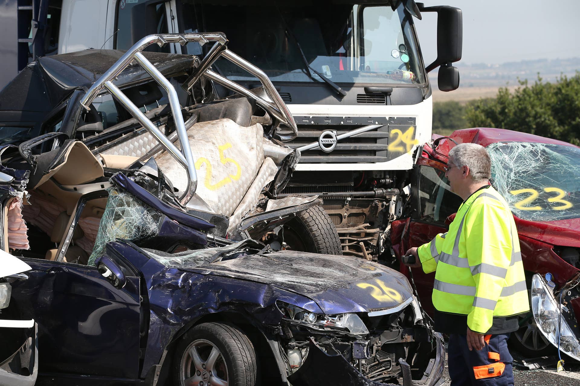 ISLE OF SHEPPEY, KENT - SEPTEMBER 05: Vehicle recovery workers attend the site of a major traffic accident on the A249 Sheppey crossing bridge in Kent on September 5, 2013 in Isle of Sheppey, Kent. Over 130 vehicles were involved in the series of accidents, with thick fog blamed for poor visibility. The crash occurred around 07:15AM BST, with at least 8 people suffering serious injuries, and approximately 60 people treated for minor injuries.  (Photo by Peter Macdiarmid/Getty Images)