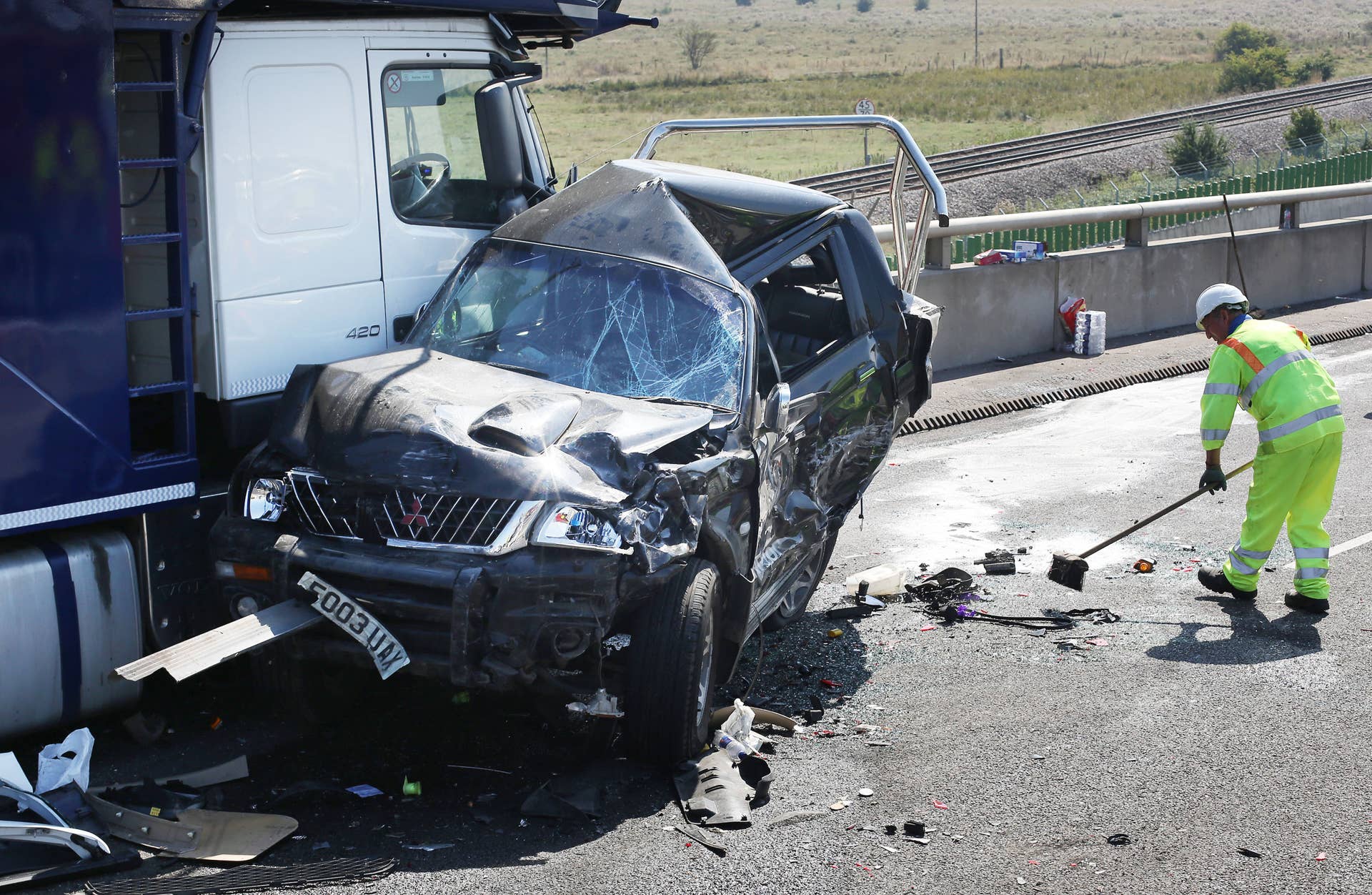 ISLE OF SHEPPEY, KENT - SEPTEMBER 05: A vehicle recovery worker brushes the road at the scene of a major traffic accident on the A249 Sheppey crossing bridge in Kent on September 5, 2013 in Isle of Sheppey, Kent. Over 130 vehicles were involved in the series of accidents, with thick fog blamed for poor visibility. The crash occurred around 07:15AM BST, with at least 8 people suffering serious injuries, and approximately 60 people treated for minor injuries. (Photo by Peter Macdiarmid/Getty Images)