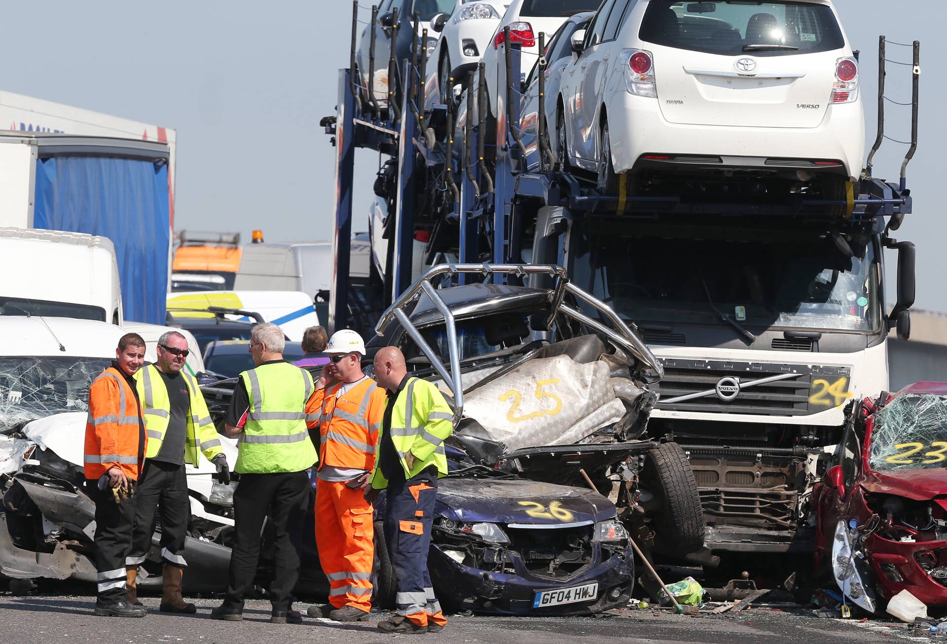 ISLE OF SHEPPEY, KENT - SEPTEMBER 05: Vehicle recovery workers attend the site of a major traffic accident on the A249 Sheppey crossing bridge in Kent on September 5, 2013 in Isle of Sheppey, Kent. Over 130 vehicles were involved in the series of accidents, with thick fog blamed for poor visibility. The crash occurred around 07:15AM BST, with at least 8 people suffering serious injuries, and approximately 60 people treated for minor injuries. (Photo by Peter Macdiarmid/Getty Images)