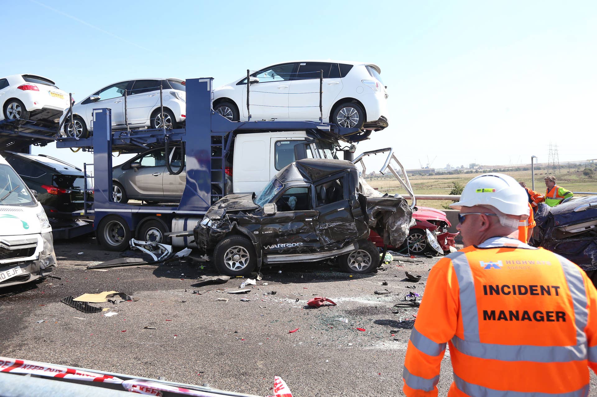 ISLE OF SHEPPEY, KENT - SEPTEMBER 05:  A vehicle recovery worker surveys the scene of a major traffic accident on the A249 Sheppey crossing bridge in Kent on September 5, 2013 in Isle of Sheppey, Kent. Over 130 vehicles were involved in the series of accidents, with thick fog blamed for poor visibility. The crash occurred around 07:15AM BST, with at least 8 people suffering serious injuries, and approximately 60 people treated for minor injuries.  (Photo by Peter Macdiarmid/Getty Images)