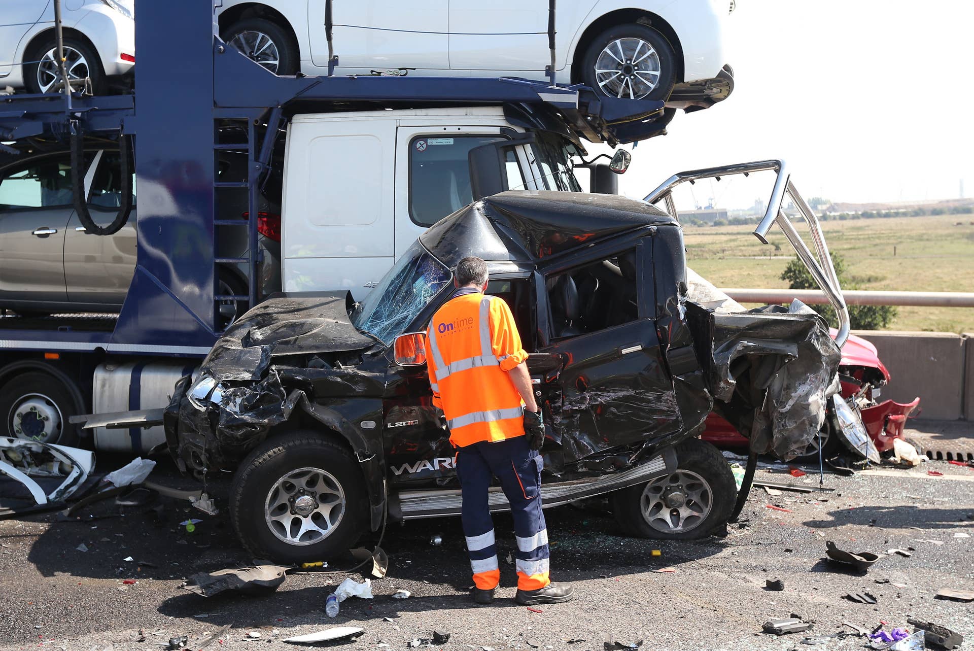 ISLE OF SHEPPEY, KENT - SEPTEMBER 05:  A vehicle recovery worker inspects the site of a major traffic accident on the A249 Sheppey crossing bridge in Kent on September 5, 2013 in Isle of Sheppey, Kent. Over 130 vehicles were involved in the series of accidents, with thick fog blamed for poor visibility. The crash occurred around 07:15AM BST, with at least 8 people suffering serious injuries, and approximately 60 people treated for minor injuries.  (Photo by Peter Macdiarmid/Getty Images)
