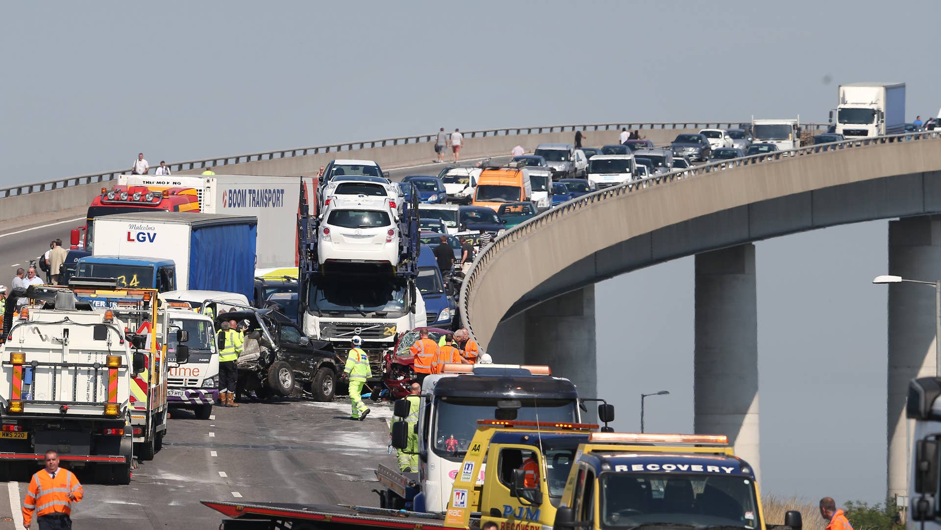 ISLE OF SHEPPEY, KENT - SEPTEMBER 05: A line of damaged vehicles await recovery on the A249 Sheppey crossing bridge in Kent after a major road crash on September 5, 2013 in Isle of Sheppey, Kent. Over 130 vehicles were involved in the series of accidents, with thick fog blamed for poor visibility. The crash occurred around 07:15AM BST, with at least 8 people suffering serious injuries, and approximately 60 people treated for minor injuries. (Photo by Peter Macdiarmid/Getty Images)
