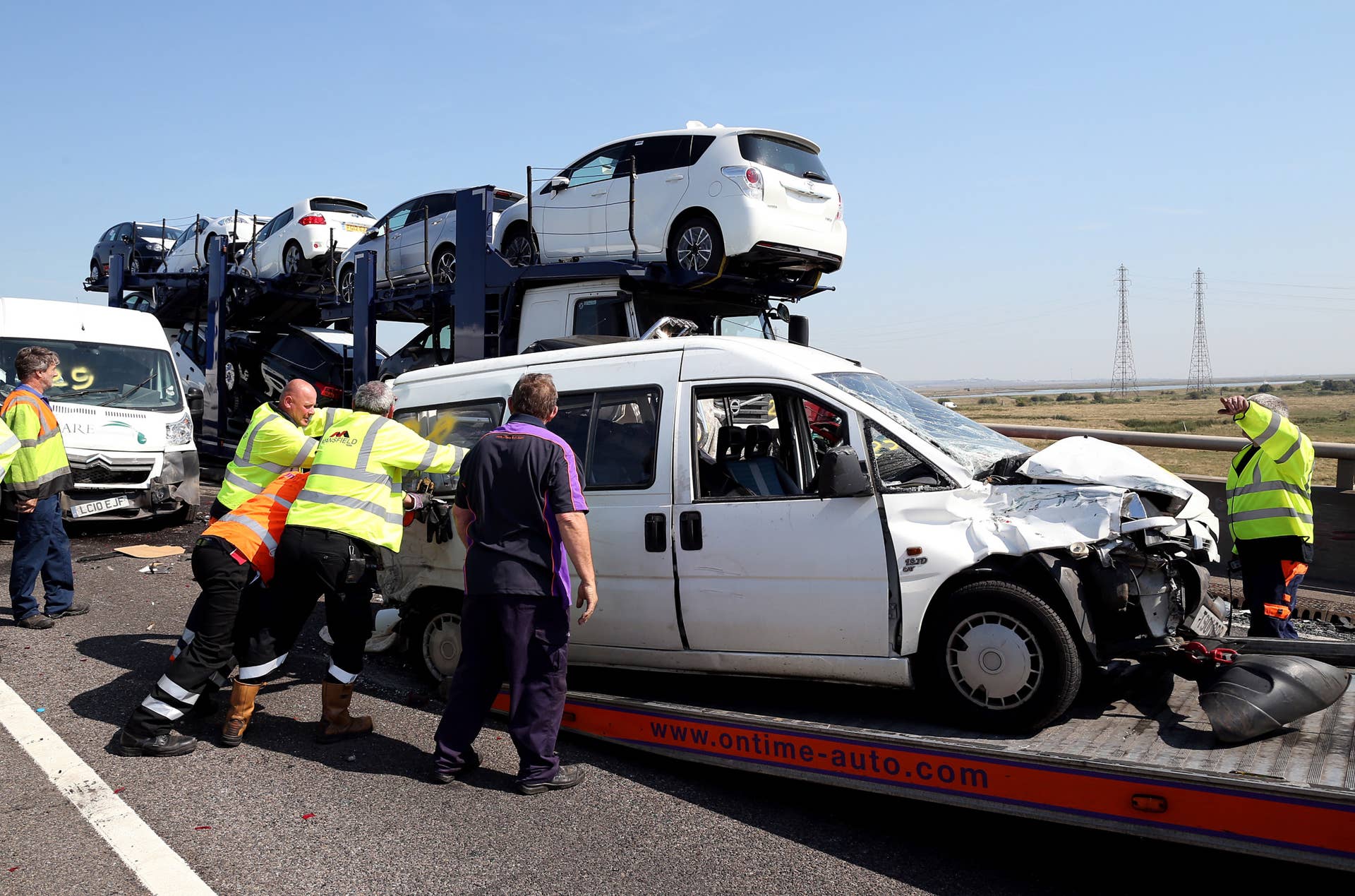 ISLE OF SHEPPEY, KENT - SEPTEMBER 05:  Vehicle recovery workers attend the site of a major traffic accident on the A249 Sheppey crossing bridge in Kent on September 5, 2013 in Isle of Sheppey, Kent. Over 130 vehicles were involved in the series of accidents, with thick fog blamed for poor visibility. The crash occurred around 07:15AM BST, with at least 8 people suffering serious injuries, and approximately 60 people treated for minor injuries.  (Photo by Peter Macdiarmid/Getty Images)