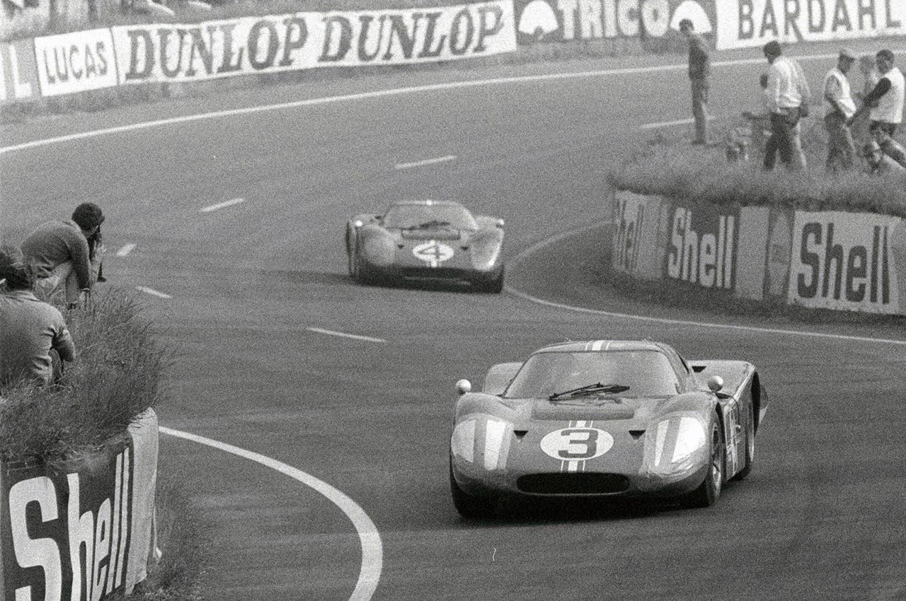 24 Hours of LeMans, LeMans, France, 1967. Mario Andretti/Lucien Bianchi leads Lloyd Ruby/Frank Gardner in the esses; both cars are Ford Mark IV. CD#0554-3252-4011-15.