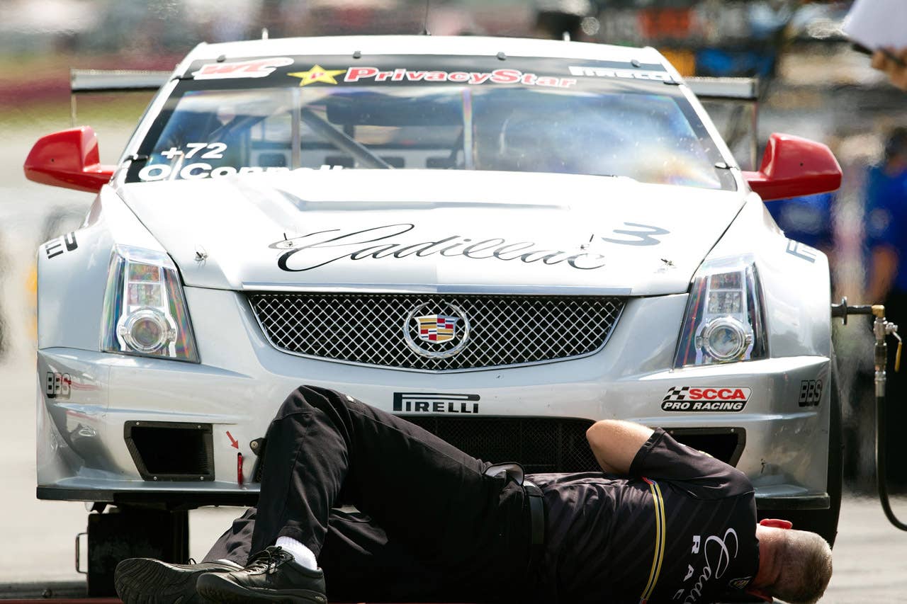 Cadillac Racing, SCCA Pro Racing World Challenge, Mid-Ohio Sports Car Course, Lexington, Ohio, August 5-7, 2011. The CTS-V Cadillac Crew Chief Mike West checks the underside of Johnny O'Connell's CTS-V during a practice session (Richard Prince/Cadillac Racing Photo).