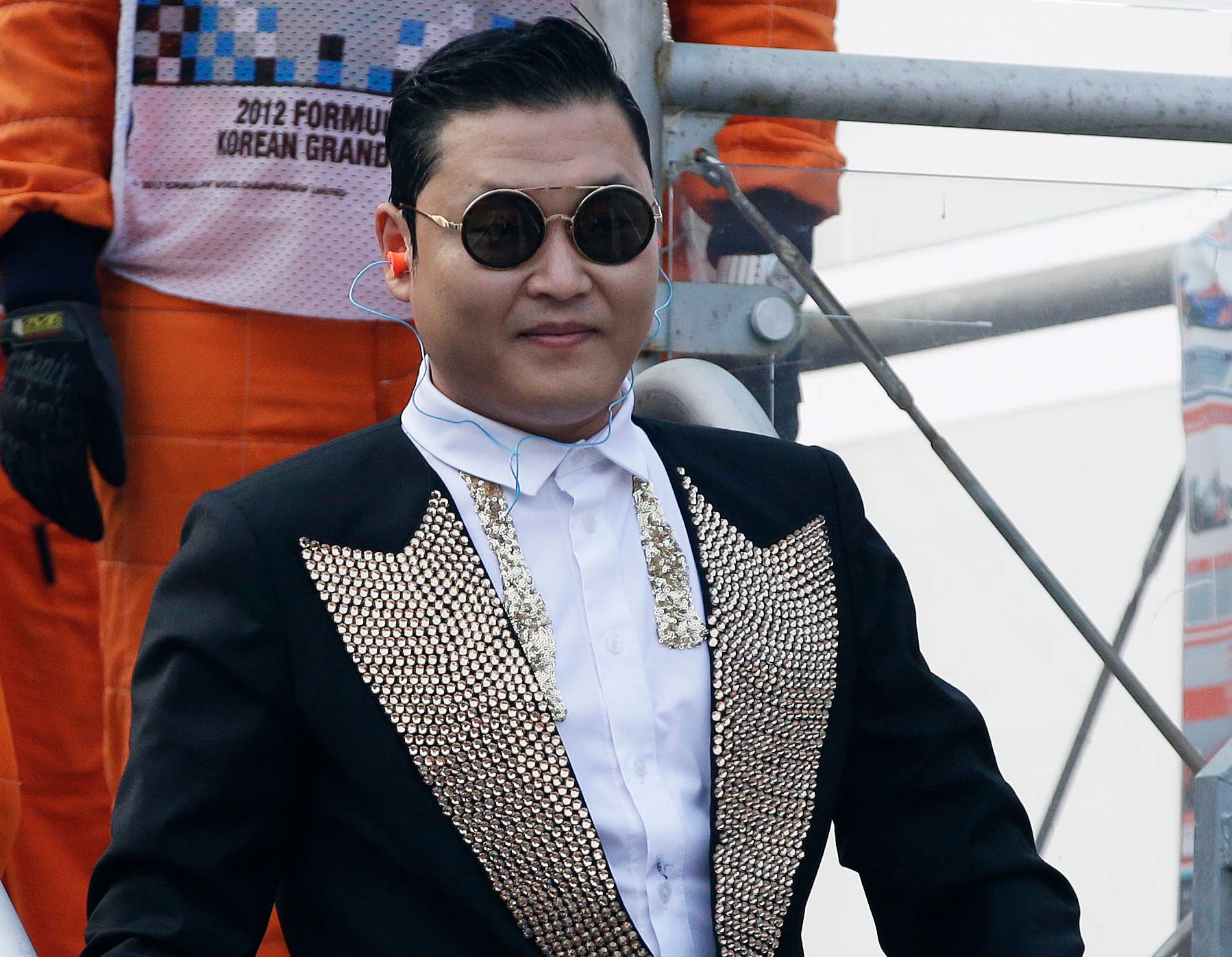 FILE - In this Oct. 14, 2012 file photo, South Korean rapper PSY leaves the finish tower after he waved the checkered flag at the conclusion of the Korean Formula One Grand Prix at the Korean International Circuit in Yeongam, South Korea. U.N. Secretary-General Ban Ki-moon  joked during a Tuesday, Oct. 23, 2012 meeting with the rapper that he felt overshadowed by the star, whose video has scored over half a billion views on YouTube. (AP Photo/Mark Baker, File)