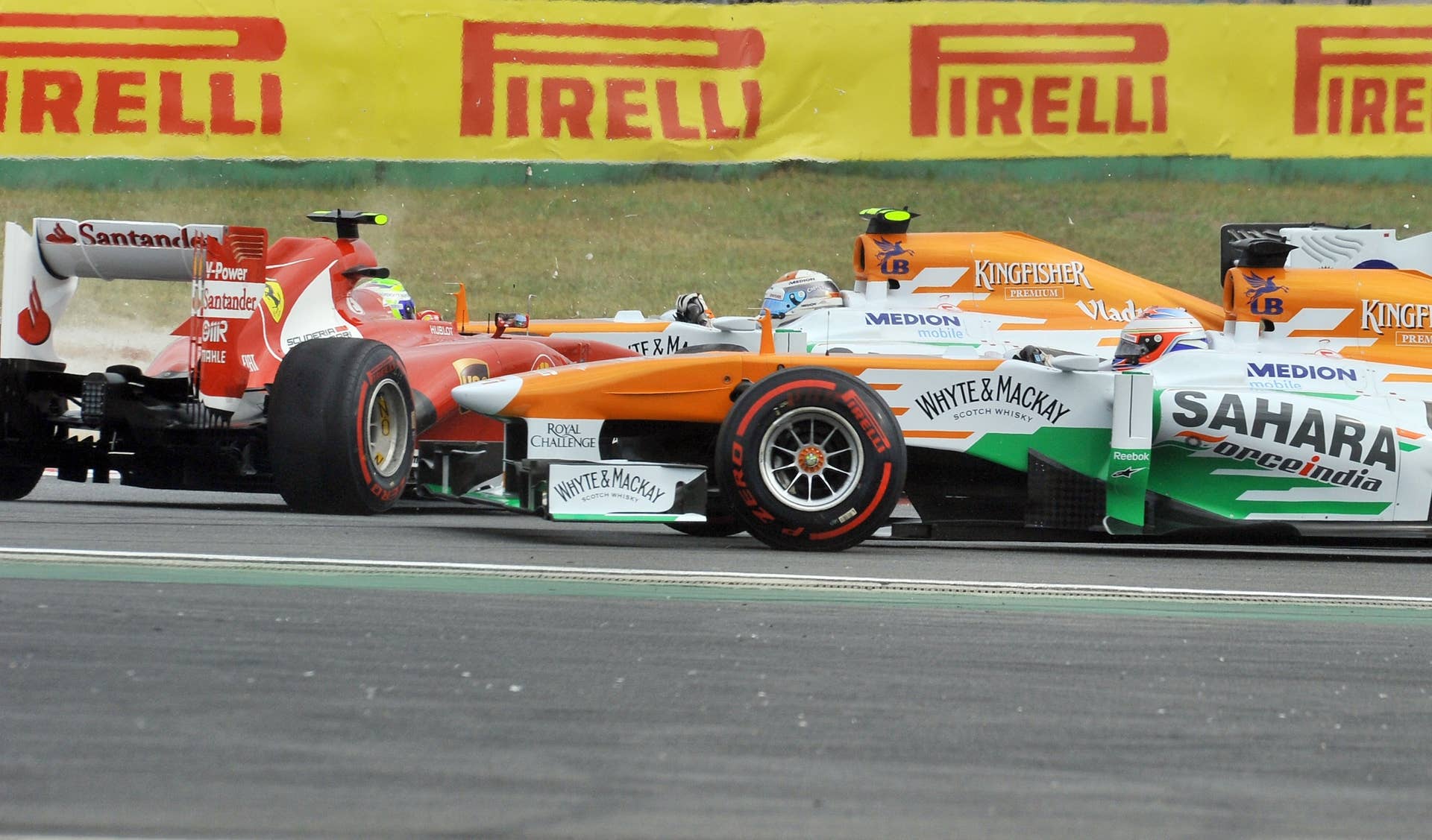 Ferrari driver Felipe Massa of Brazil (L) turns around as Force India driver Paul Di Resta of Britain (R) and Force India driver Adrian Sutil of Germany (C) drive past during the Formula One Korean Grand Prix in Yeongam on October 6, 2013.  AFP PHOTO / JUNG YEON-JE        (Photo credit should read JUNG YEON-JE/AFP/Getty Images)