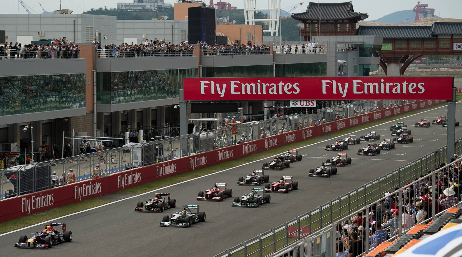 Cars come down the straight at the start of the Formula One Korean Grand Prix in Yeongam on October 6, 2013. AFP PHOTO/ Nicolas ASFOURI        (Photo credit should read NICOLAS ASFOURI/AFP/Getty Images)