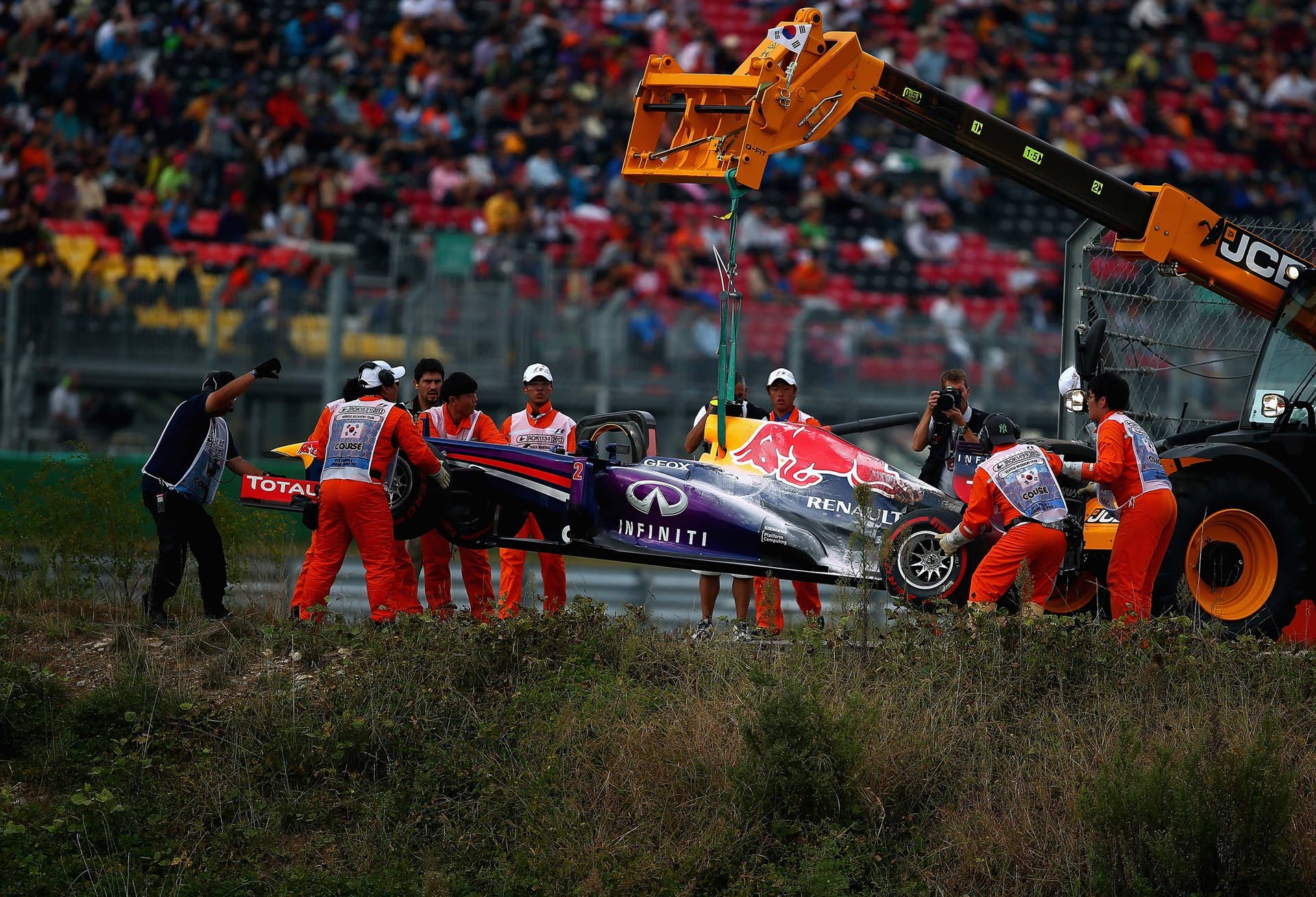 YEONGAM-GUN, SOUTH KOREA - OCTOBER 06:  Mark Webber of Australia and Infiniti Red Bull Racing is lifted from the track after he retires early from the Korean Formula One Grand Prix at Korea International Circuit on October 6, 2013 in Yeongam-gun, South Korea.  (Photo by Clive Mason/Getty Images)