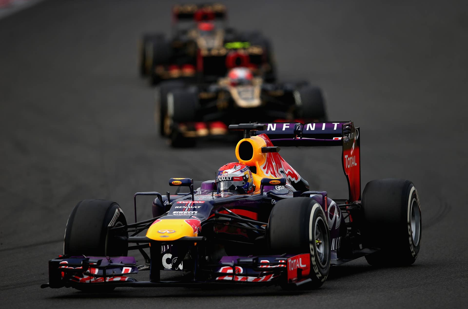 YEONGAM-GUN, SOUTH KOREA - OCTOBER 06:  Sebastian Vettel of Germany and Infiniti Red Bull Racing leads from Romain Grosjean of France and Lotus and Kimi Raikkonen of Finland and Lotus during the Korean Formula One Grand Prix at Korea International Circuit on October 6, 2013 in Yeongam-gun, South Korea.  (Photo by Clive Mason/Getty Images)