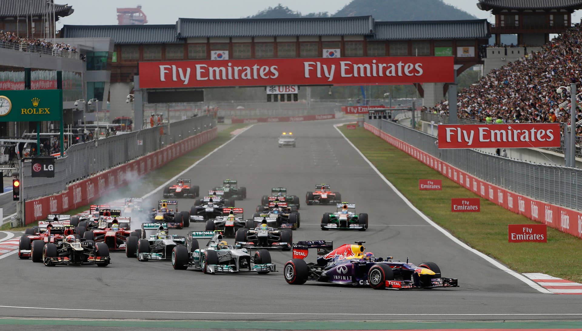 Red Bull driver Sebastian Vettel of Germany leads the field into turn one at the start of the drivers parade ahead of  the Korean Formula One Grand Prix at the Korean International Circuit in Yeongam, South Korea, Sunday, Oct. 6, 2013. (AP Photo/Mark Baker)