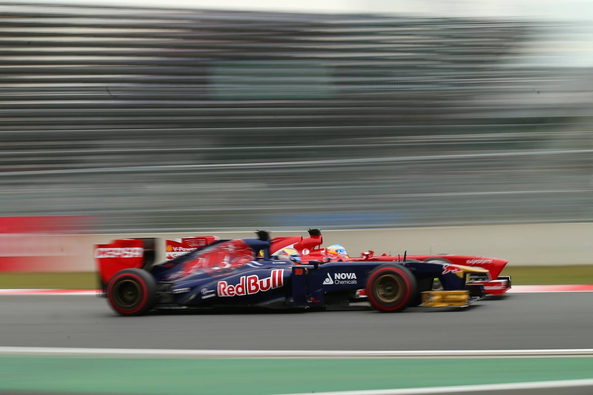 YEONGAM-GUN, SOUTH KOREA - OCTOBER 06:  Jean-Eric Vergne of France and Scuderia Toro Rosso and Fernando Alonso of Spain and Ferrari drive side by side during the Korean Formula One Grand Prix at Korea International Circuit on October 6, 2013 in Yeongam-gun, South Korea.  (Photo by Clive Rose/Getty Images)