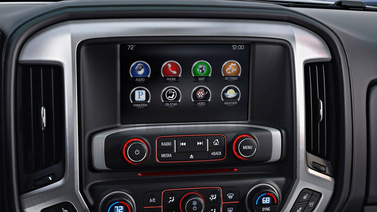 The all new interior on the 2014 GMC Sierra SLT features a 8" Color Touch Screen radio with Intellilink.  The GMC Sierra also features real chrome trim surround the center console; a feature not available in the Chevy Silverado