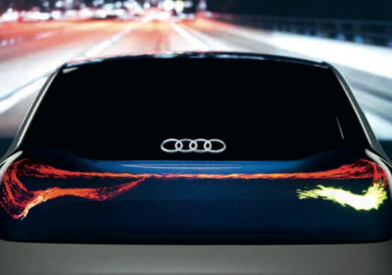 OLED Technology    Audi was among the first automakers to offer full LED lighting on its vehicles, and the next logical step is the use of OLEDs, or"organic light emitting diodes."  If you follow the consumer electronics industry, you've seen OLED technology used in everything from smartphones to TVs. Unlike LEDs, which are made up of semiconducting crystals, OLEDs are an organic polymer that act like semiconductors. This pastey material is only a few nanometers thick and spans the space between the anode and cathode, both of which are enveloped in an electrically conductive coating.