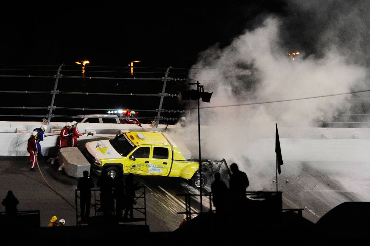 DAYTONA BEACH, FL - FEBRUARY 27:  Safety workers try to extinguish a fire from a jet dryer after being hit by Juan Pablo Montoya, driver of the #42 Target Chevrolet, under caution during the NASCAR Sprint Cup Series Daytona 500 at Daytona International Speedway on February 27, 2012 in Daytona Beach, Florida.  (Photo by John Harrelson/Getty Images for NASCAR)
