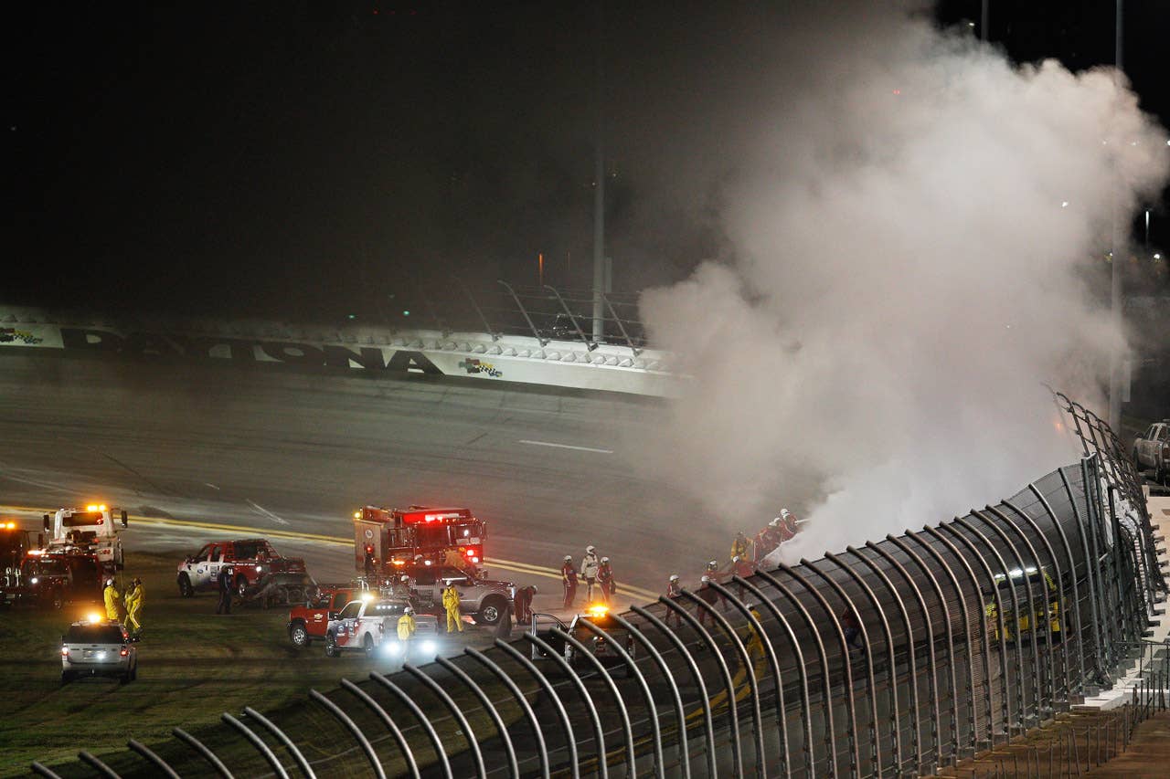 DAYTONA BEACH, FL - FEBRUARY 27:  Safety workers try to extinguish a fire from a jet dryer after being hit by Juan Pablo Montoya, driver of the #42 Target Chevrolet, under caution during the NASCAR Sprint Cup Series Daytona 500 at Daytona International Speedway on February 27, 2012 in Daytona Beach, Florida.  (Photo by Chris Graythen/Getty Images)