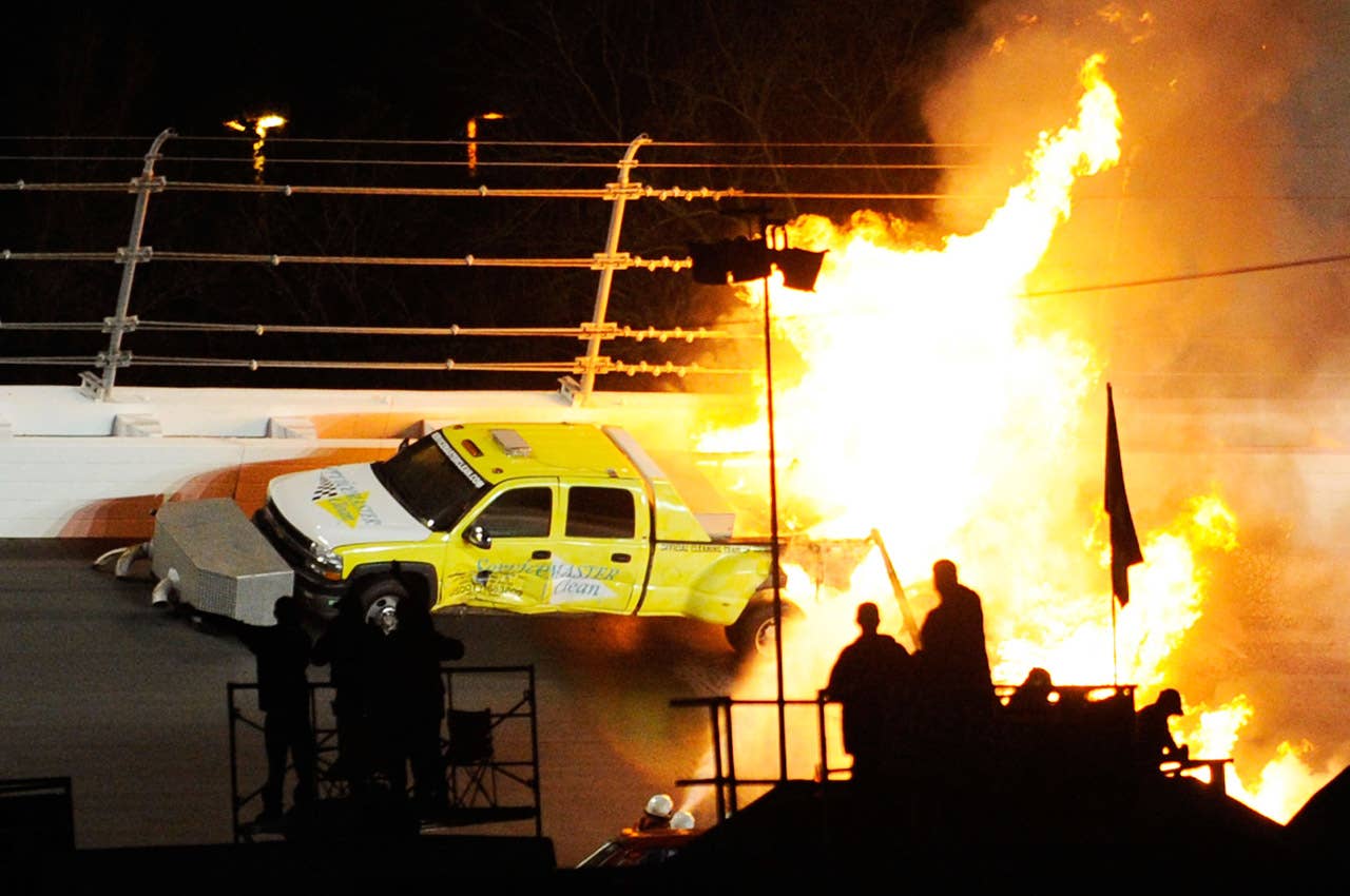 DAYTONA BEACH, FL - FEBRUARY 27:  Safety workers try to extinguish a fire from a jet dryer after being hit by Juan Pablo Montoya, driver of the #42 Target Chevrolet, under caution during the NASCAR Sprint Cup Series Daytona 500 at Daytona International Speedway on February 27, 2012 in Daytona Beach, Florida.  (Photo by John Harrelson/Getty Images for NASCAR)