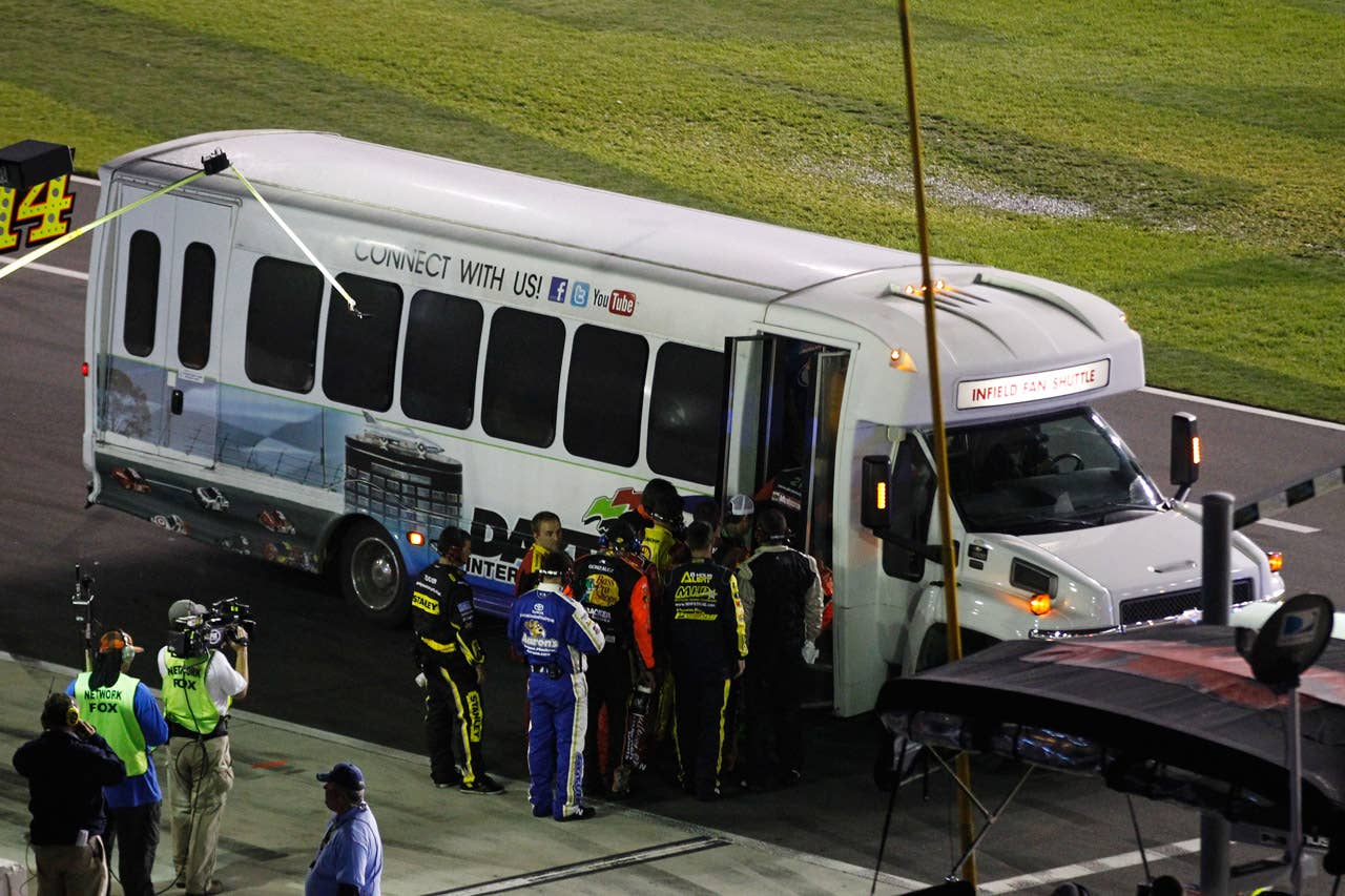 DAYTONA BEACH, FL - FEBRUARY 27:  Crew members board a bus to take them to the backstretch to tend to their drivers during a red flag in the NASCAR Sprint Cup Series Daytona 500 at Daytona International Speedway on February 27, 2012 in Daytona Beach, Florida.  (Photo by Streeter Lecka/Getty Images)
