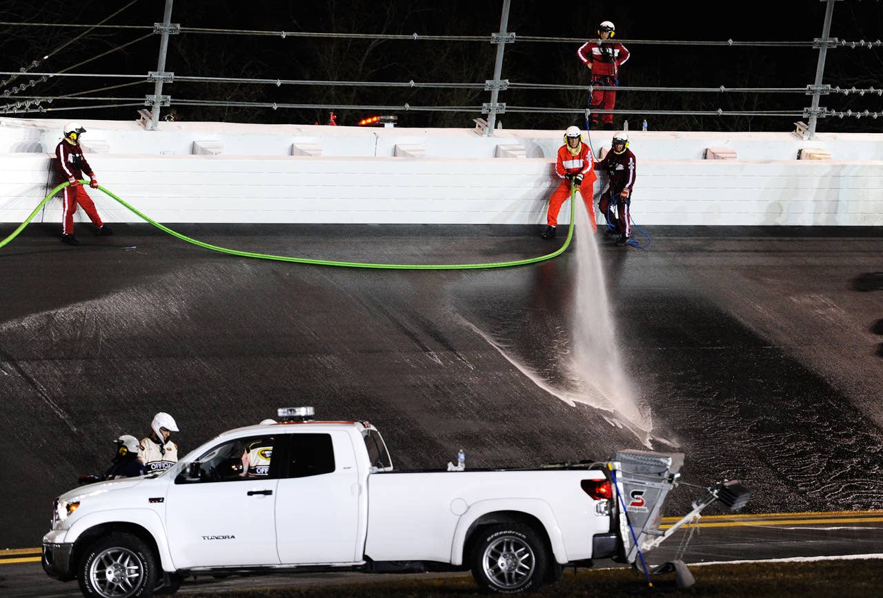 DAYTONA BEACH, FL - FEBRUARY 27:  Safety workers clean up the track after a jet dryer burst into flames after being hit under caution by Juan Pablo Montoya, driver of the #42 Target Chevrolet, during the NASCAR Sprint Cup Series Daytona 500 at Daytona International Speedway on February 27, 2012 in Daytona Beach, Florida.  (Photo by John Harrelson/Getty Images for NASCAR)