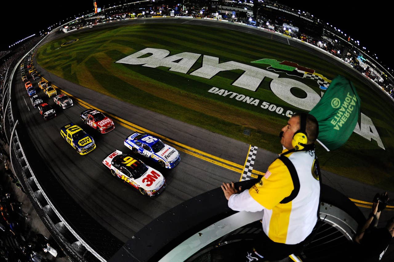 DAYTONA BEACH, FL - FEBRUARY 27:  Carl Edwards, driver of the #99 Fastenal Ford, and Greg Biffle, driver of the #16 3M Ford, lead the field to the green flag to start the NASCAR Sprint Cup Series Daytona 500 at Daytona International Speedway on February 27, 2012 in Daytona Beach, Florida.  (Photo by Chris Graythen/Getty Images)