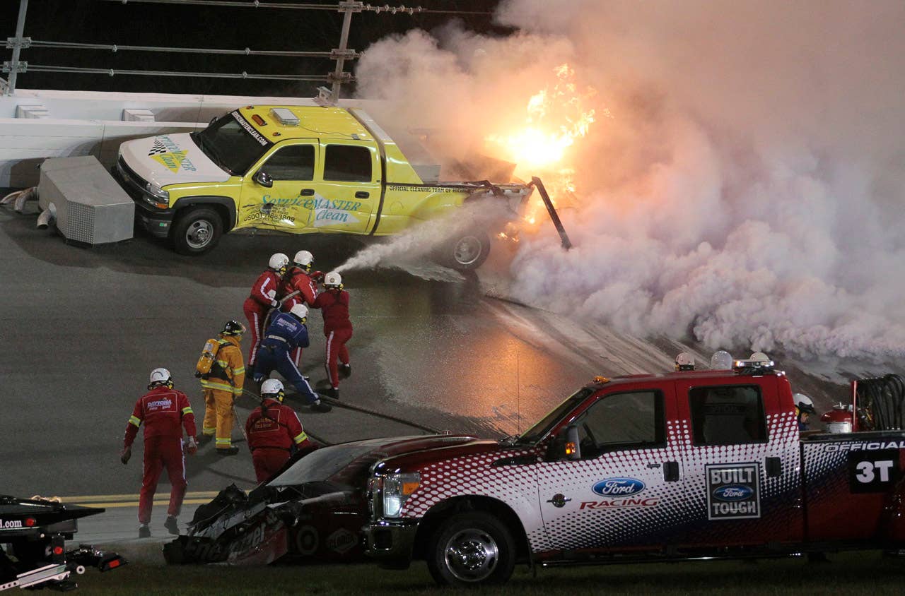 Emergency workers put out a fire on a jet dryer during the NASCAR Daytona 500 auto race at Daytona International Speedway in Daytona Beach, Fla., Monday, Feb. 27, 2012. (AP Photo/Bill Friel)