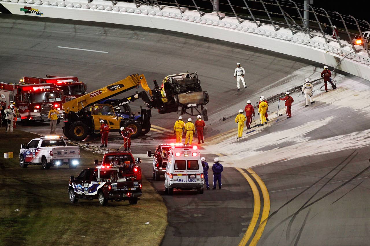 DAYTONA BEACH, FL - FEBRUARY 27:  Safety workers clean up the track after a jet dryer burst into flames after being hit under caution by Juan Pablo Montoya, driver of the #42 Target Chevrolet, during the NASCAR Sprint Cup Series Daytona 500 at Daytona International Speedway on February 27, 2012 in Daytona Beach, Florida.  (Photo by Jonathan Ferrey/Getty Images for NASCAR)
