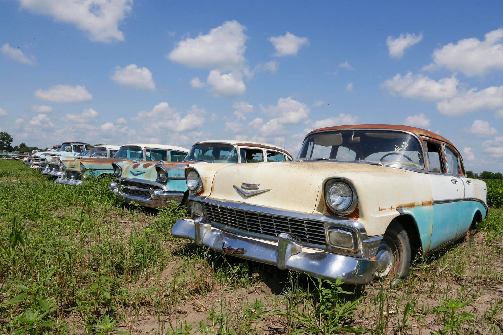In this Aug. 12, 2013 photo, Chevrolet automobiles are lined up in a field near the former Lambrecht Chevrolet car dealership in Pierce, Neb. In September, bidders from at least a dozen countries and all 50 U.S. states will converge on Pierce, a town of about 1,800 in northeast Nebraska, for a two-day auction that will feature about 500 old cars and trucks, mostly Chevrolets that went unsold during the dealership?s five decades in business. About 50 have fewer than 20 miles on the odometer, and some are so rare that no one has established a price. The most valuable could fetch six-figure bids. (AP Photo/Nati Harnik)