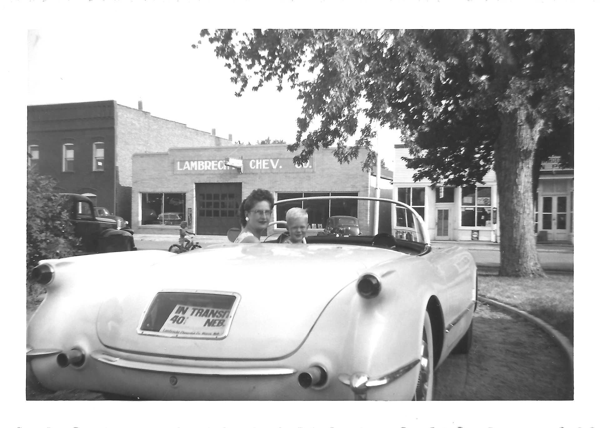This family photo which was provided by Jeannie Stillwell, daughter of Ray Lambrecht of the Lambrecht Chevrolet car company in Pierce, Neb., shows Mildred Lambrecht, wife of Ray, and their son Mark in a brand new 1953 Corvette, in front of the dealership. In September 2013, bidders from at least a dozen countries and all 50 U.S. states will converge on Pierce, a town of about 1,800 in northeast Nebraska, for a two-day auction that will feature about 500 old cars and trucks, mostly Chevrolets that went unsold during the dealership?s five decades in business. About 50 have fewer than 20 miles on the odometer, and some are so rare that no one has established a price. The most valuable could fetch six-figure bids. (AP Photo/Jeannie Stillwell Family)