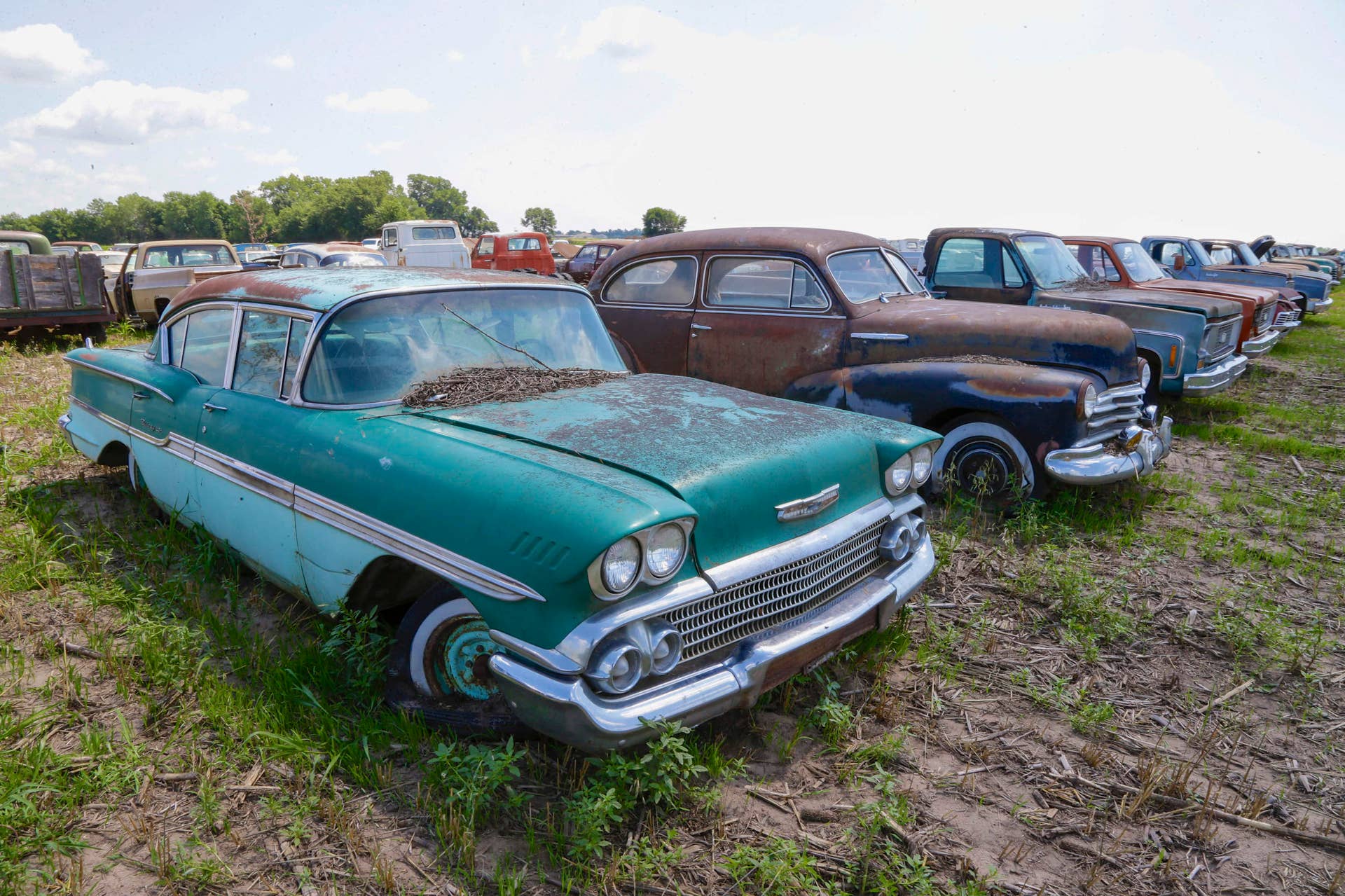 A 1958 Chevrolet Biscayne is lined up with others at a field near the former Lambrecht Chevrolet car dealership in Pierce, Neb. in an Aug. 12, 2013 photo. Next month, bidders from at least a dozen countries and all 50 U.S. states will converge on Pierce, a town of about 1,800 in northeast Nebraska, for a two-day auction that will feature about 500 old cars and trucks, mostly Chevrolets that went unsold during the dealership?s five decades in business. About 50 have fewer than 20 miles on the odometer, and some are so rare that no one has established a price. The most valuable could fetch six-figure bids. (AP Photo/Nati Harnik)