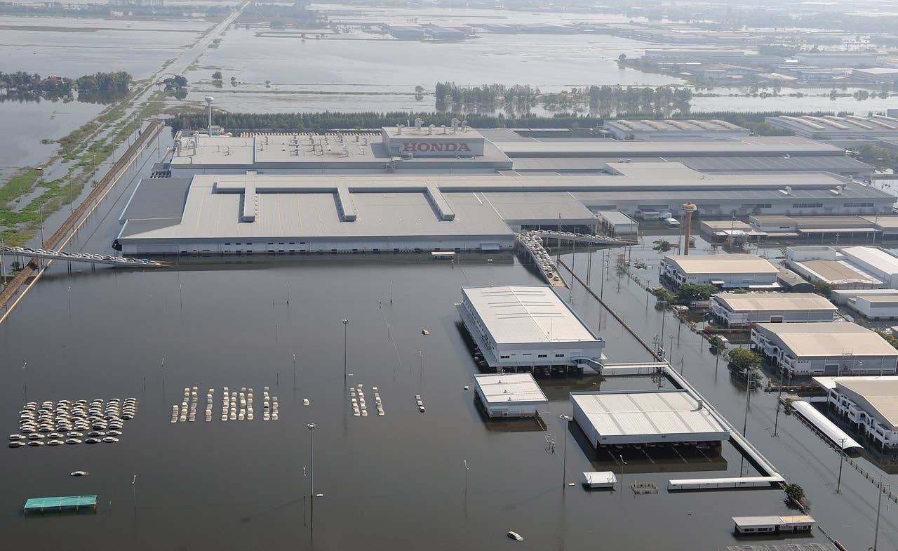 This aerial picture shows cars (L) submerged in floodswaters at a Honda automotive factory in Ayutthaya province, north of Bangkok on November 19, 2011. Thailand's worst floods in decades may gradually be subsiding but ripples will be felt by companies and consumers for months to come, analysts say, underlining the fragility of the global supply chain. AFP PHOTO / Pornchai KITTIWONGSAKUL (Photo credit should read PORNCHAI KITTIWONGSAKUL/AFP/Getty Images)