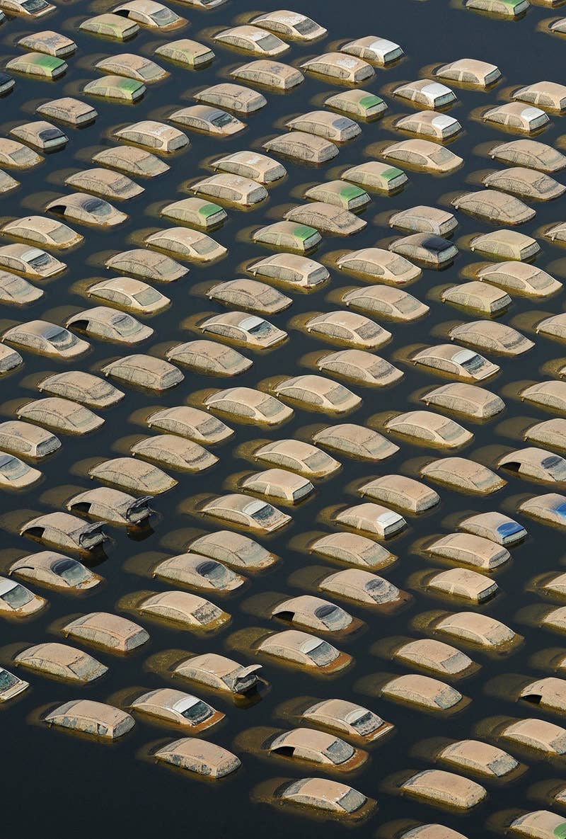 TO GO WITH 'THAILAND-FLOODS-ECONOMY-BUSINESS' by Kelly Macnamara (FILES) This aerial picture shows cars submerged in floodwaters at a Honda automotive factory at an industrial estate in Ayutthaya province on November 19, 2011. Huge swathes of central Thailand were left under water for weeks when severe monsoon rains caused massive inundations, ruining crops, closing thousands of factories and swamping millions of homes. Hundreds of thousands of people were put out of work when the floodwaters swept into key industrial estates in Ayutthaya and on the outskirts of the capital Bangkok. AFP PHOTO / Pornchai KITTIWONGSAKUL (Photo credit should read PORNCHAI KITTIWONGSAKUL/AFP/Getty Images)