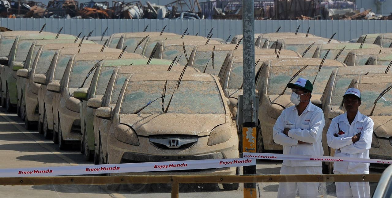 Flood damaged cars sit at the Honda factory in Ayutthaya province on December 27, 2011. Japanese car assembler Honda automobile (Thailand) started to scrap 1,055 cars which were damaged by the recent floods in Thailand, ensuring that damaged parts would not be sold, the company said in statement. AFP PHOTO/PORNCHAI KITTIWONGSAKUL (Photo credit should read PORNCHAI KITTIWONGSAKUL/AFP/Getty Images)