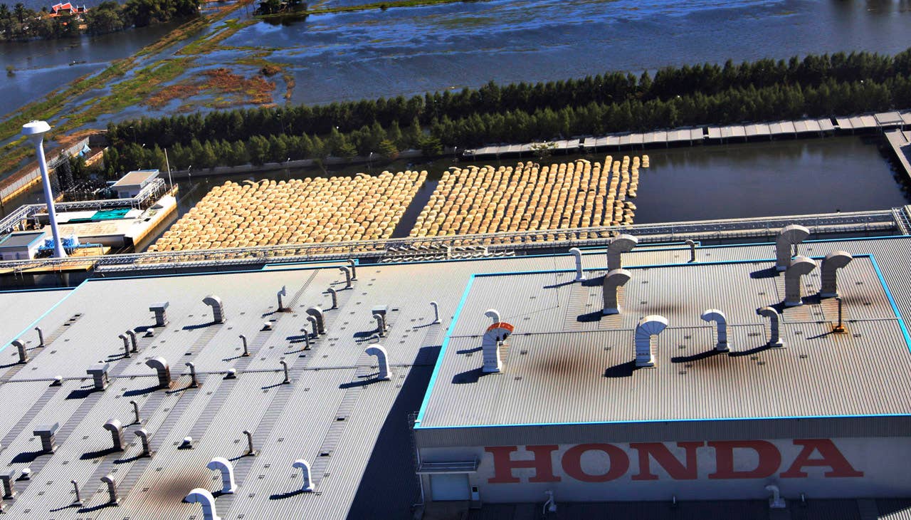 Vehicles, center, at Honda auto factory are submerged in floodwaters at the Rojana industrial district in Ayutthaya, central Thailand Wednesday, Nov. 23, 2011. Honda's auto factory in Thailand remains closed because of the floodwaters. (AP Photo/Sakchai Lalit)