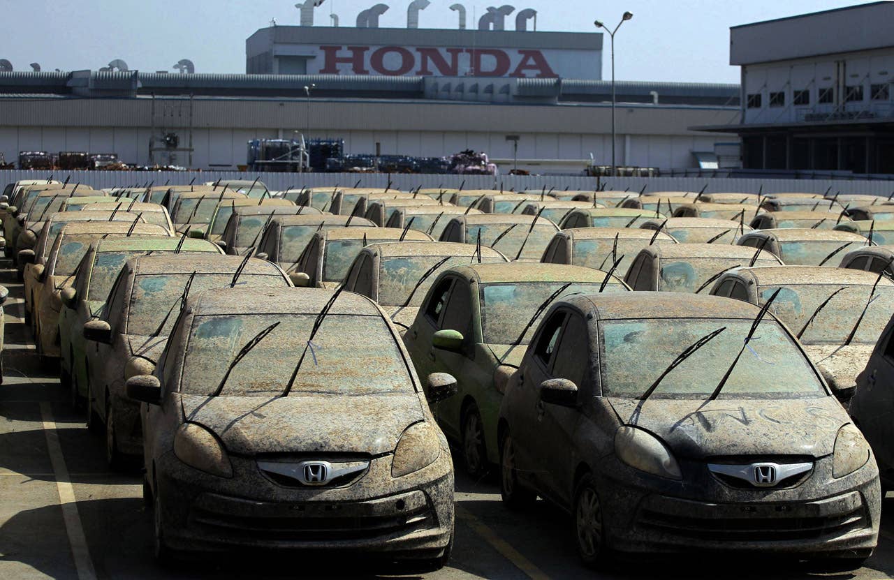 Honda cars that were damaged because of the flood are parked on the ground while waiting to be destroyed at a Honda automobile plant in Ayutthaya province, central Thailand Tuesday, Dec. 27, 2011. The 1,055 unit of Honda cars, mostly Brio eco-cars and City subcompacts, were destroyed in an action to assure to customers that the flood-damaged cars will not be repaired and sold. (AP Photo/Apichart Weerawong)