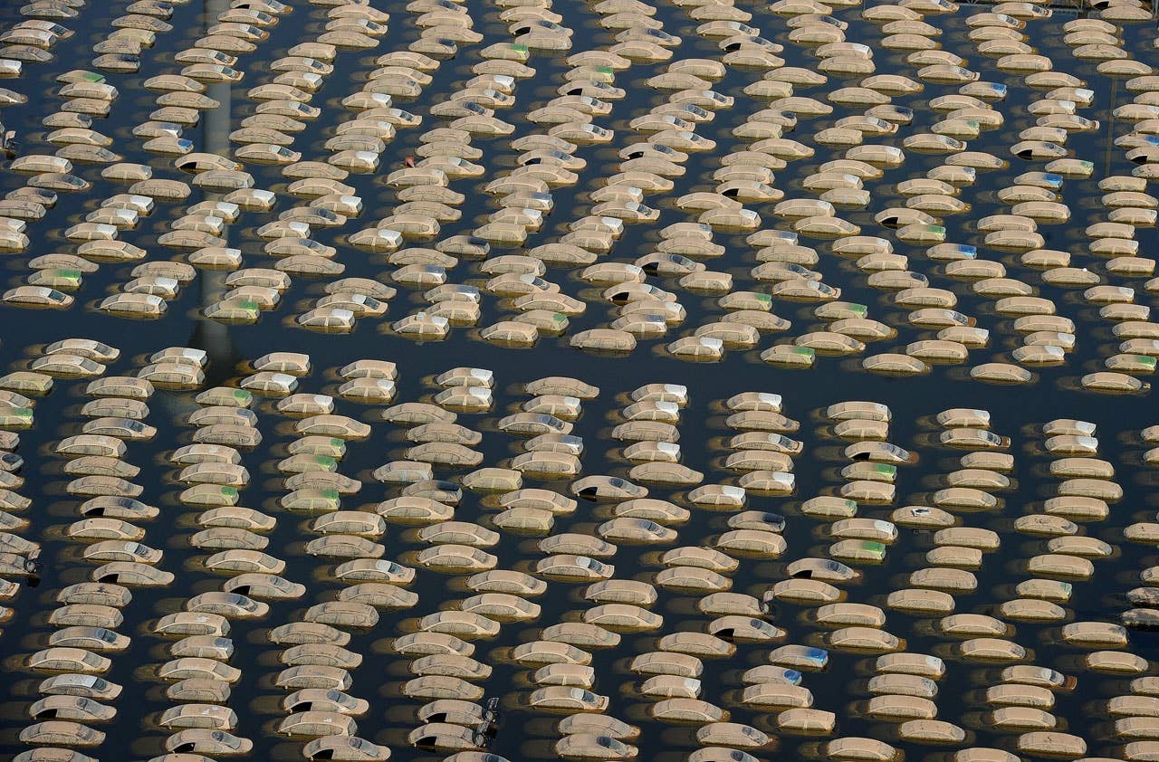 This aerial picture shows cars submerged in floodswaters at a Honda automotive factory in Ayutthaya province, north of Bangkok on November 19, 2011. Thailand's worst floods in decades may gradually be subsiding but ripples will be felt by companies and consumers for months to come, analysts say, underlining the fragility of the global supply chain. AFP PHOTO / Pornchai KITTIWONGSAKUL (Photo credit should read PORNCHAI KITTIWONGSAKUL/AFP/Getty Images)