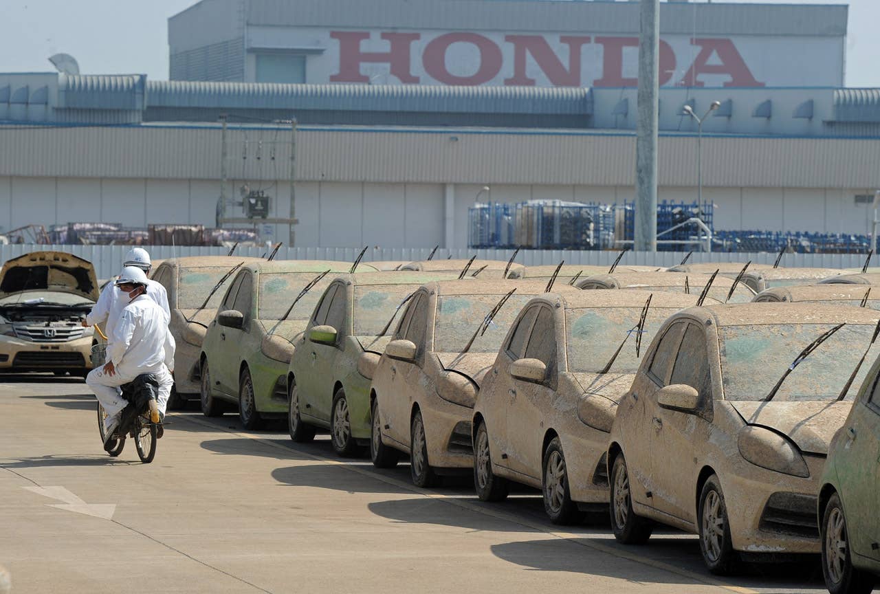 Flood damaged cars sit at the Honda factory in Ayutthaya province on December 27, 2011. Japanese car assembler Honda automobile (Thailand) started to scrap 1,055 cars which were damaged by the recent floods in Thailand, ensuring that damaged parts would not be sold, the company said in statement. AFP PHOTO/PORNCHAI KITTIWONGSAKUL (Photo credit should read PORNCHAI KITTIWONGSAKUL/AFP/Getty Images)
