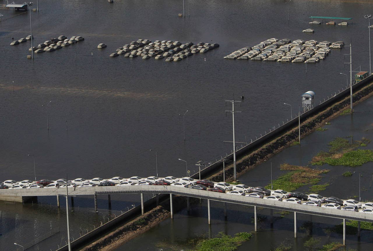 Vehicles at Honda auto factory are submerged in floodwaters at the Rojana industrial district in Ayutthaya, central Thailand Wednesday, Nov. 23, 2011. Honda's auto factory in Thailand remains closed because of the floodwaters. (AP Photo/Sakchai Lalit)