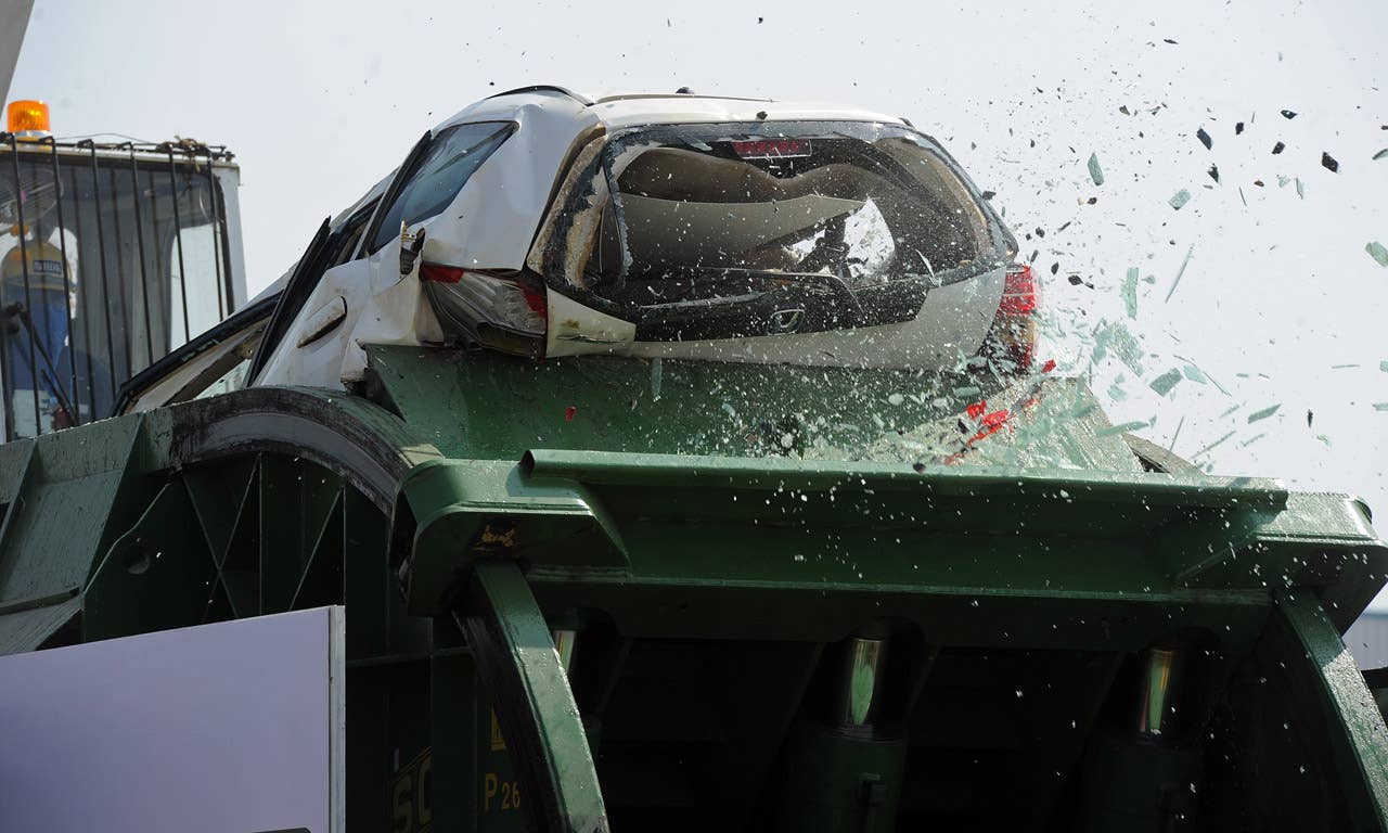A flood damaged Honda car is destroyed at the Honda factory in Ayutthaya province on December 27, 2011. Japanese car assembler Honda automobile (Thailand) started to scrap 1,055 cars which were damaged by the recent floods in Thailand, ensuring that damaged parts would not be sold, the company said in statement. AFP PHOTO/PORNCHAI KITTIWONGSAKUL (Photo credit should read PORNCHAI KITTIWONGSAKUL/AFP/Getty Images)