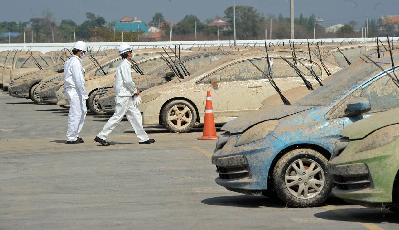 Flood damaged cars sit at the Honda factory in Ayutthaya province on December 27, 2011.  Japanese car assembler Honda automobile (Thailand) started to scrap 1,055 cars which were damaged by the recent floods in Thailand, ensuring that damaged parts would not be sold, the company said in statement.  AFP PHOTO/PORNCHAI KITTIWONGSAKUL (Photo credit should read PORNCHAI KITTIWONGSAKUL/AFP/Getty Images)