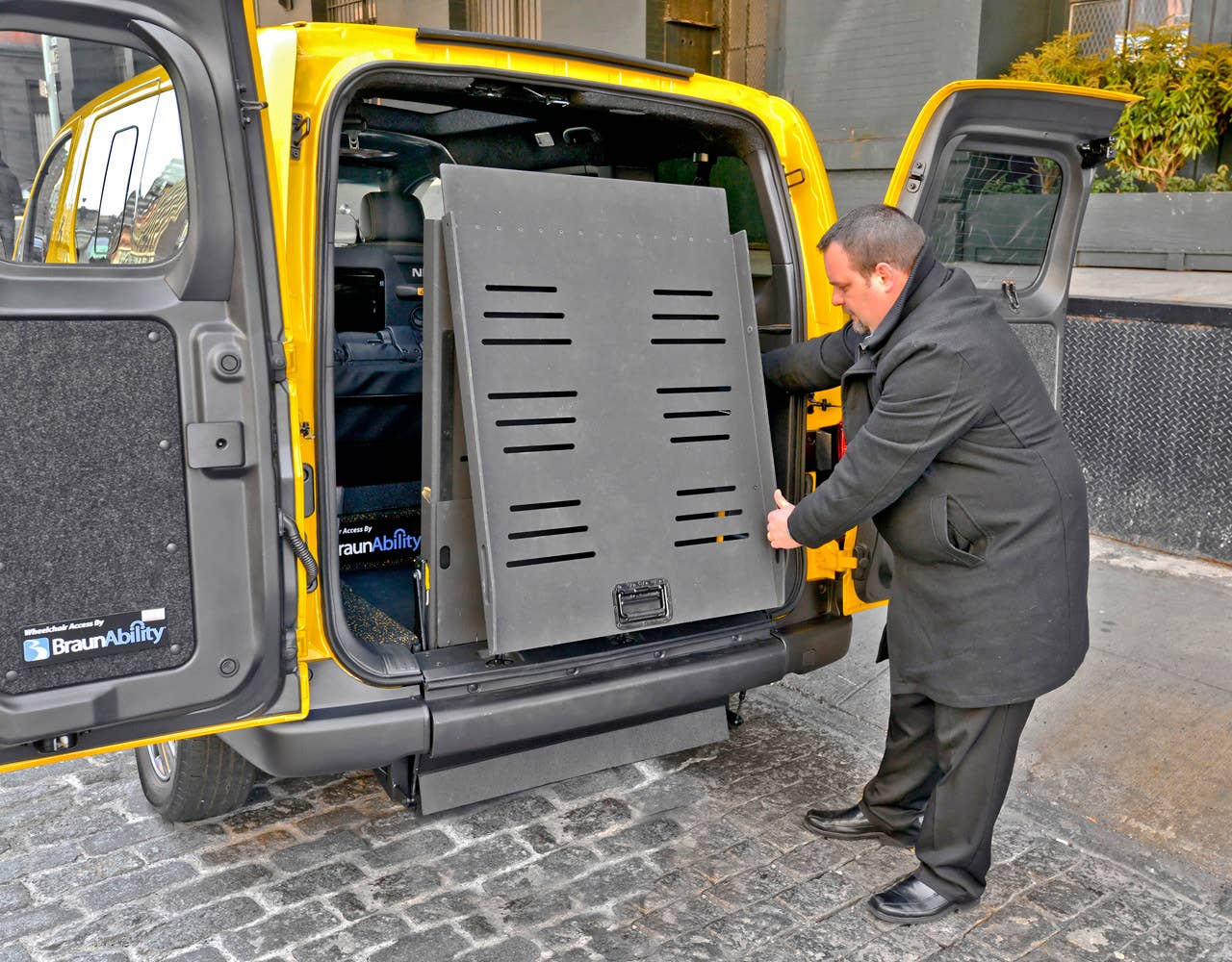 NEW YORK (Mar. 27, 2013)  As Nissans innovative NV200 taxi gets ready to take to the streets of New York City this coming fall, another crucial part of the Taxi of Tomorrow program was unveiled today at the New York International Auto Show  the wheelchair accessible NV200 Mobility NY Taxi. Working in conjunction with BraunAbility, the Indiana-based market leader in wheelchair accessible vehicles and wheelchair lifts, the Nissan NV200 Mobility Taxi features a rear-entry ramp and an industry-first integrated restraint system that provides safe and quick securement of wheelchairs.