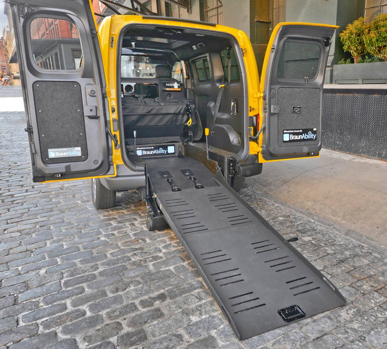 NEW YORK (Mar. 27, 2013)  As Nissans innovative NV200 taxi gets ready to take to the streets of New York City this coming fall, another crucial part of the Taxi of Tomorrow program was unveiled today at the New York International Auto Show  the wheelchair accessible NV200 Mobility NY Taxi. Working in conjunction with BraunAbility, the Indiana-based market leader in wheelchair accessible vehicles and wheelchair lifts, the Nissan NV200 Mobility Taxi features a rear-entry ramp and an industry-first integrated restraint system that provides safe and quick securement of wheelchairs.