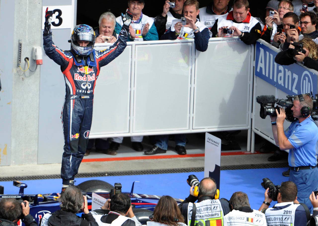 Red Bull driver Sebastian Vettel of Germany cheers as he wins the Belgian Formula One Grand Prix in Spa-Francorchamps, Sunday, Aug. 28, 2011. Red Bull driver Mark Webber of Australia placed second, and McLaren Mercedes driver Jenson Button of Britain placed third. (AP Photo/Geert Vanden Wijngaert)