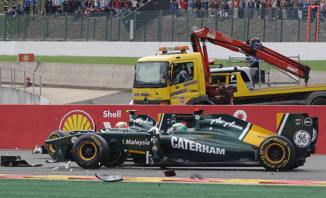 Lotus driver Heikki Kovalainen of Finland drives through debris at the start of the Belgian Formula One Grand Prix in Spa-Francorchamps, Sunday, Aug. 28, 2011. (AP Photo/Frank Augstein)