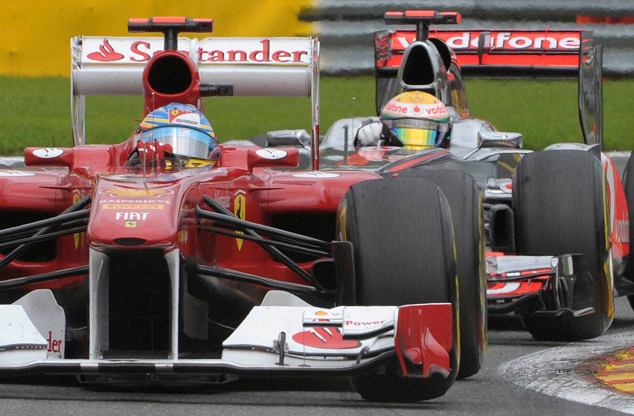McLaren Mercedes driver Lewis Hamilton of Britain, background, chases Ferrari driver Fernando Alonso of Spain during the Belgian Formula One Grand Prix in Spa-Francorchamps, Sunday, Aug. 28, 2011. Red Bull driver Sebastian Vettel of Germany won the race, Red Bull driver Mark Webber of Australia placed second, and McLaren Mercedes driver Jenson Button of Britain placed third. (AP Photo/Geert Vanden Wijngaert)