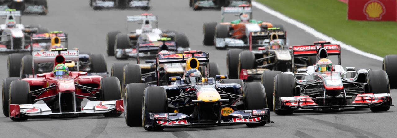 Ferrari driver Felipe Massa of Brazil, left, Red Bull driver Sebastian Vettel of Germany, center, and McLaren Mercedes driver Lewis Hamilton of Britain, right, steer their cars at the Belgian Formula One Grand Prix in Spa-Francorchamps, Sunday, Aug. 28, 2011. Red Bull driver Sebastian Vettel of Germany won the race, Red Bull driver Mark Webber of Australia placed second, and McLaren Mercedes driver Jenson Button of Britain placed third. (AP Photo/Yves Logghe)