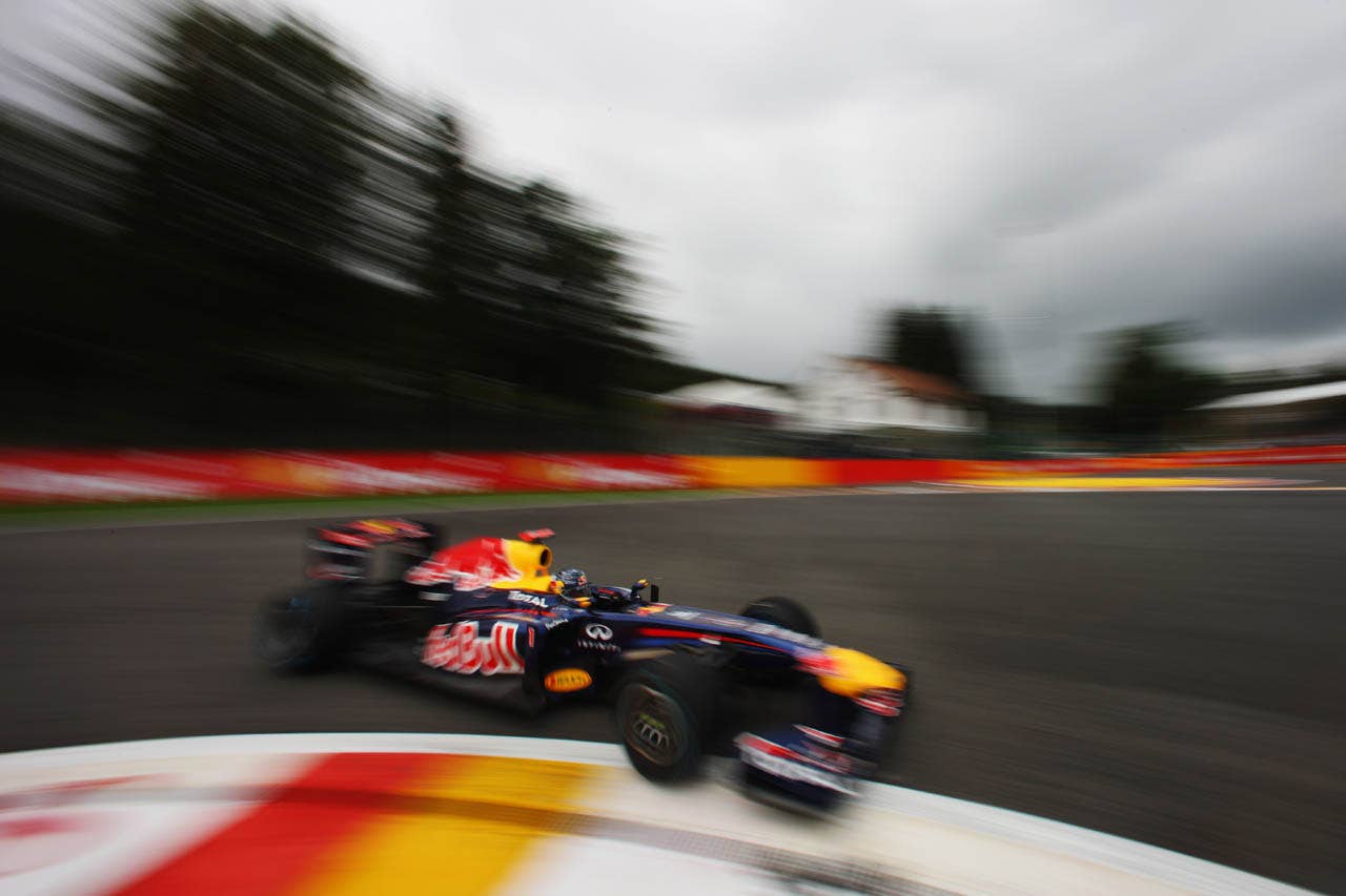 SPA FRANCORCHAMPS, BELGIUM - AUGUST 27:  Sebastian Vettel of Germany and Red Bull Racing drives on his way to finishing first during qualifying for the Belgian Formula One Grand Prix at the Circuit of Spa Francorchamps on August 27, 2011 in Spa Francorchamps, Belgium.  (Photo by Mark Thompson/Getty Images)